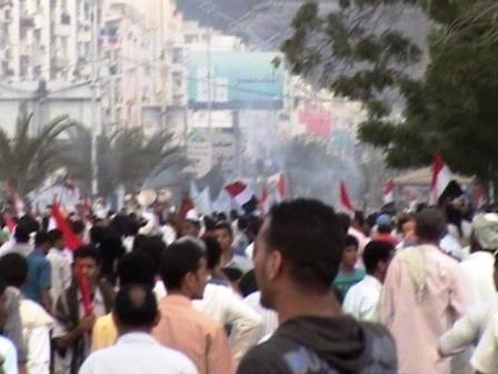 مسيرة حزب (الإصلاح) وهي تتجه إلى شارع المعلا الرئيسي وتبدو فيها أعلام الجمهورية اليمنية مرفوعة من قبل المتظاهرين.