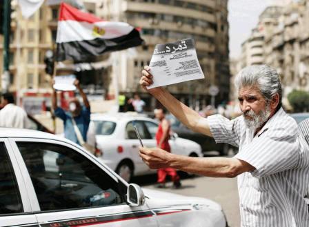 كهل مصري في أحد شوارع القاهرة يساهم في حملة سحب الثقة من الإخوان
